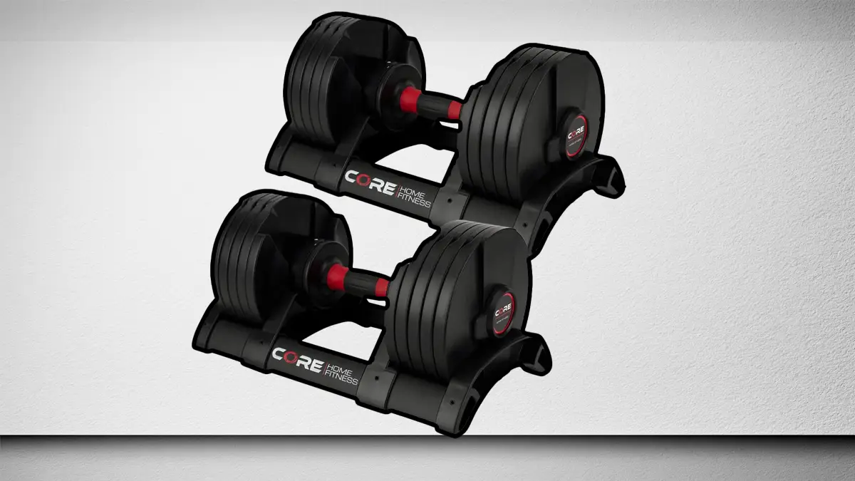 Core Fitness adjustable dumbbells with twist lock mechanism on storage cradles for a compact home gym setup